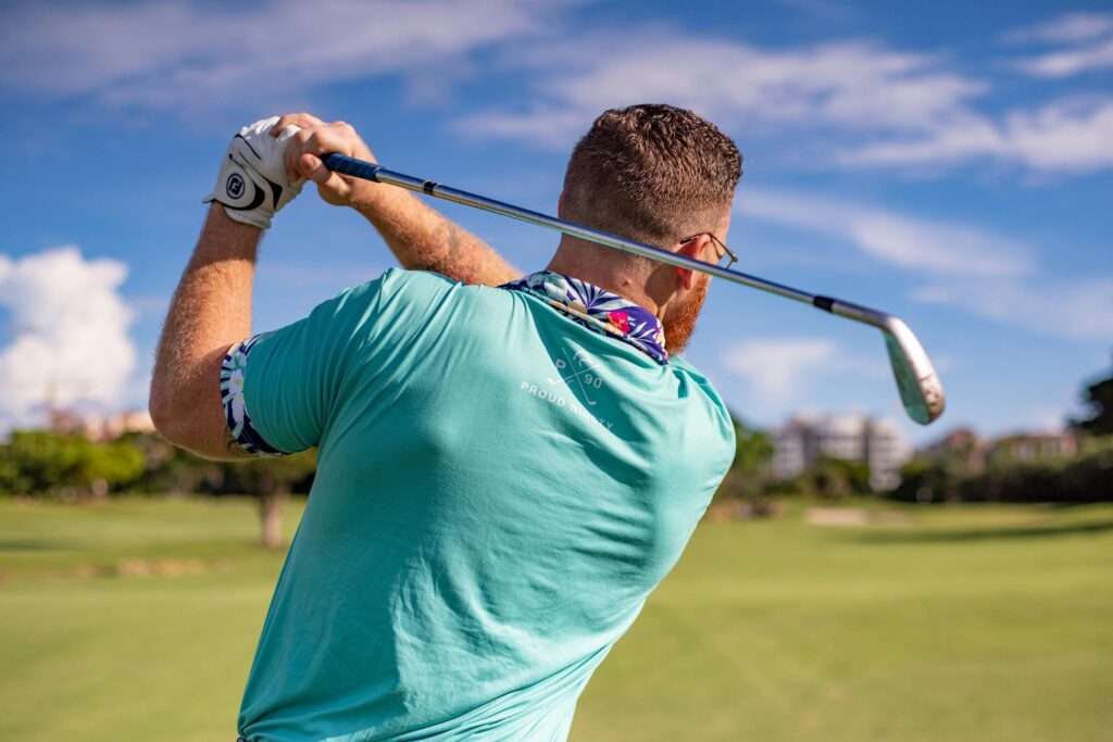 golfer swinging iron club image