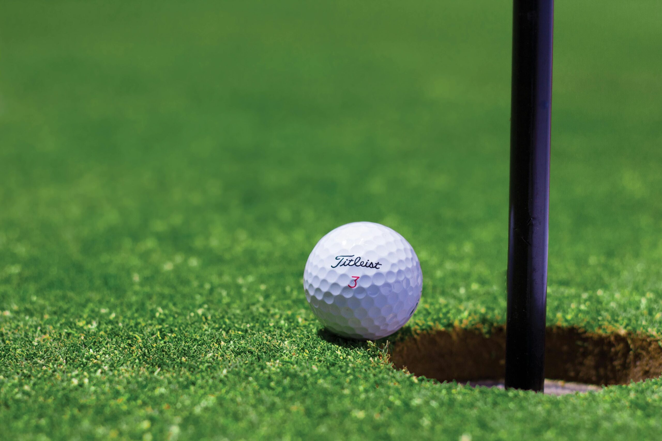longest drive in golf - image of golf ball entering the hole